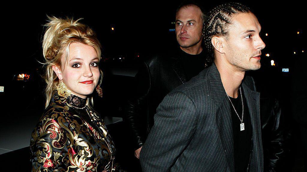 Britney Spears and Kevin Federline are seen walking into an event. Britney is wearing a dress and Kevin is in a black T-shirt and jacket.
