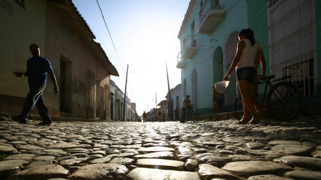 People walking on a cobbled street in Trinidad, Cuba