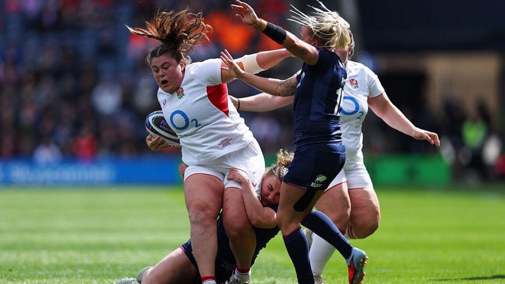 Maud Muir carries the ball