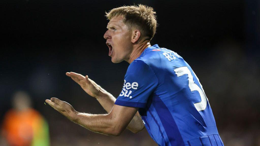 Close up of Portsmouth's Matt Ritchie clapping hands and shouting in encouragement at his team-mates during a match