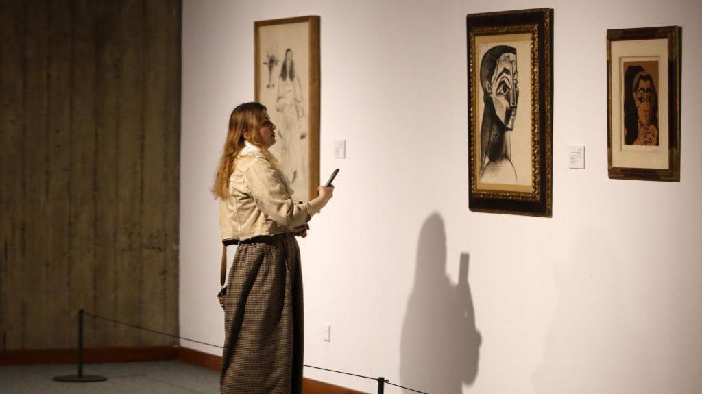 A woman looking at a painting by Pablo Picasso in Tehran Museum of Contemporary Art 