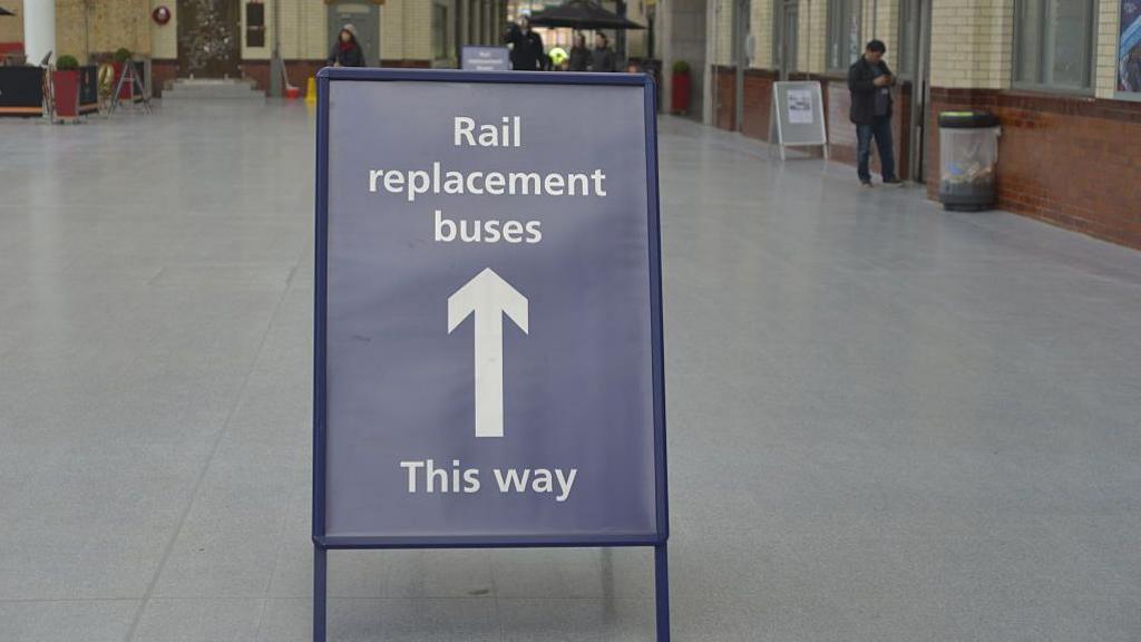 A sign at a railway station showing the availability of rail replacement bus services