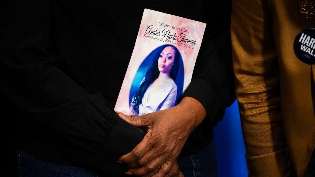 Shanette Williams, the mother of Amber Nicole Thurman, who ProPublica reported died in 2022 from a treatable infection due to delays to her medical care stemming from Georgia's restrictive abortion law, holds a photo of her daughter as she meets with US Vice President and Democratic presidential candidate Kamala Harris backstage