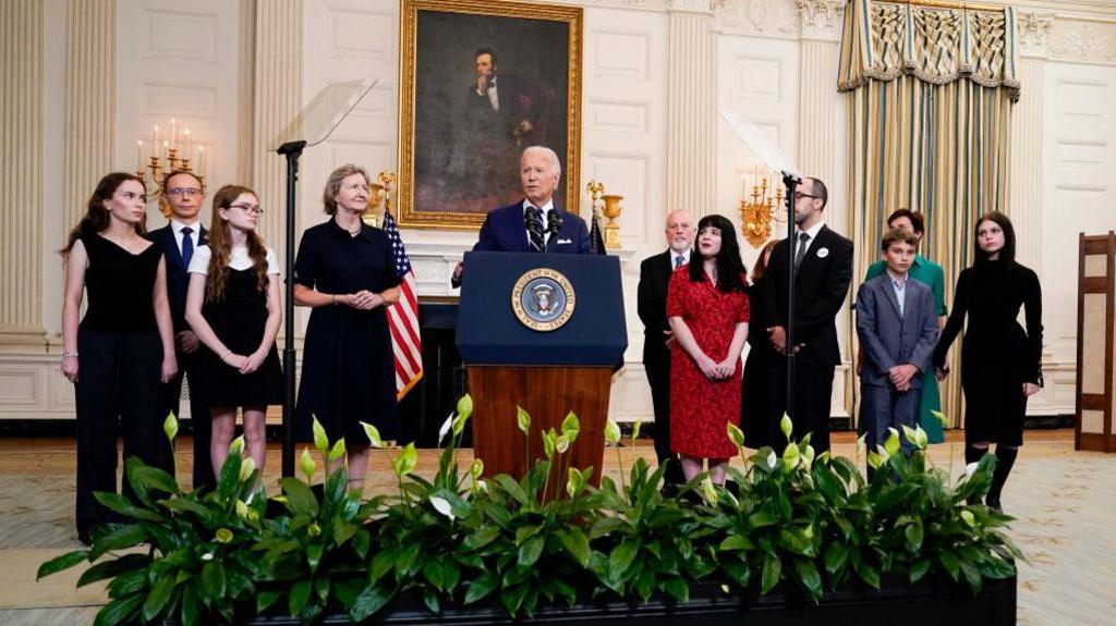 President Biden (in the centre) is joined by relatives of freed prisoners at the White House