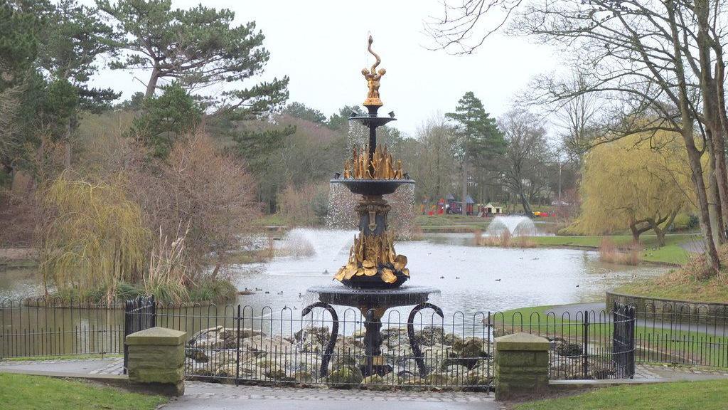 An ornate fountain by a lake in Hesketh Park