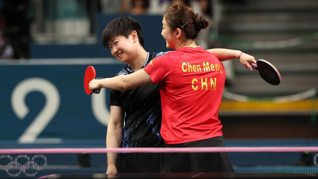 Chen Meng (right) and Sun Yingsha embrace after the table tennis women's singles final