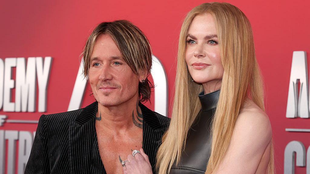 Keith Urban and Nicole Kidman appear on a red carpet for a country music honours award show in May.