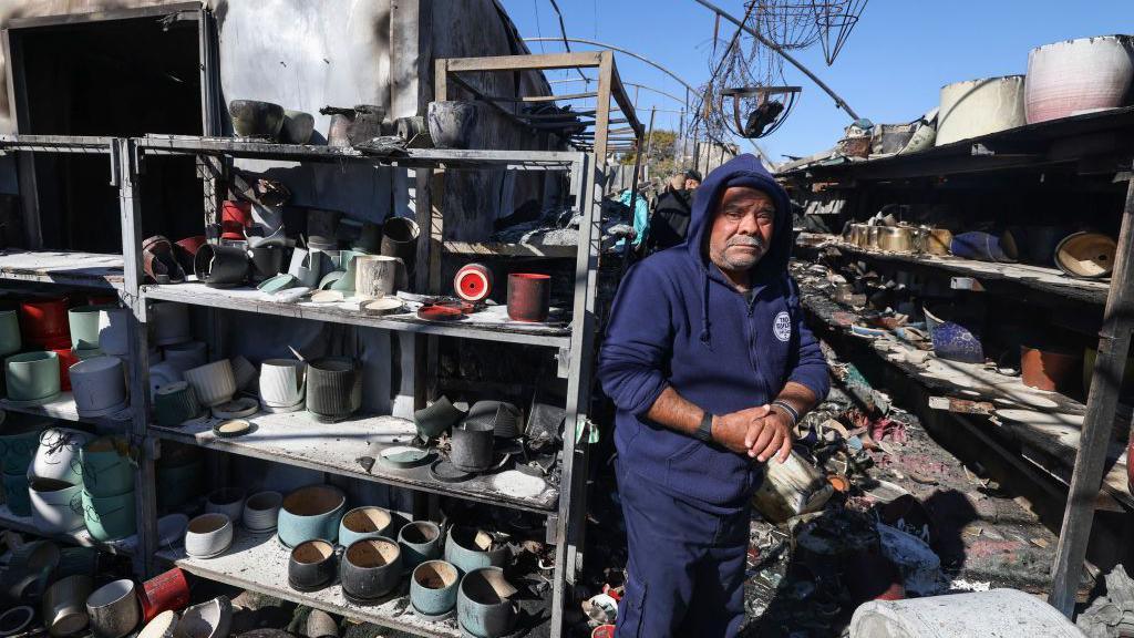 Palestinians inspect a shop that was set on fire during an attack by suspected Israeli settlers in Jinsafut village, east of Qalqilya, in the occupied West Bank (21 January 2025)