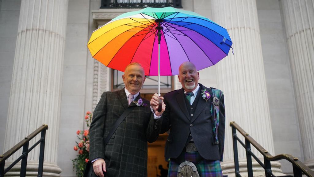 Andy Lambert, 68, (left) and Mel Fawcus, 73, from Shepherd's Bush, London, on the steps at Old Marylebone Town Hal