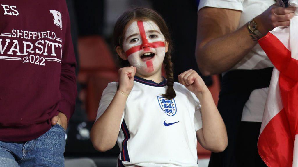 girl in england flag facepaint and football shirt