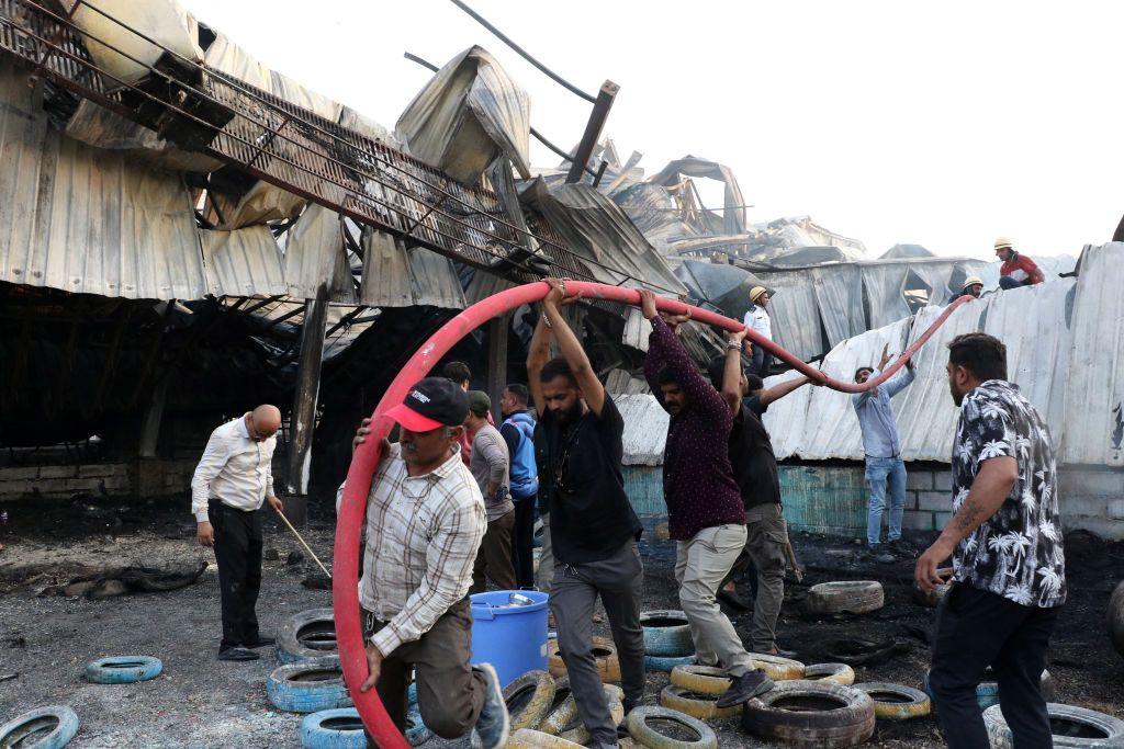 Firefighters try to extinguish a fire which broke out at an amusement park facility in Rajkot, in India's Gujarat state on May 25, 2024