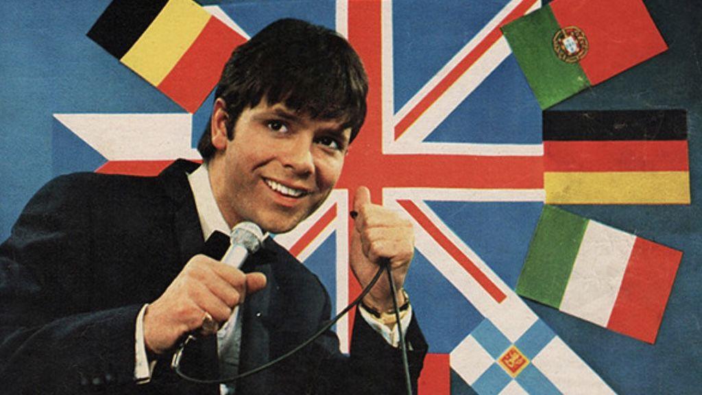 Cliff Richard poses against a selection of European flags