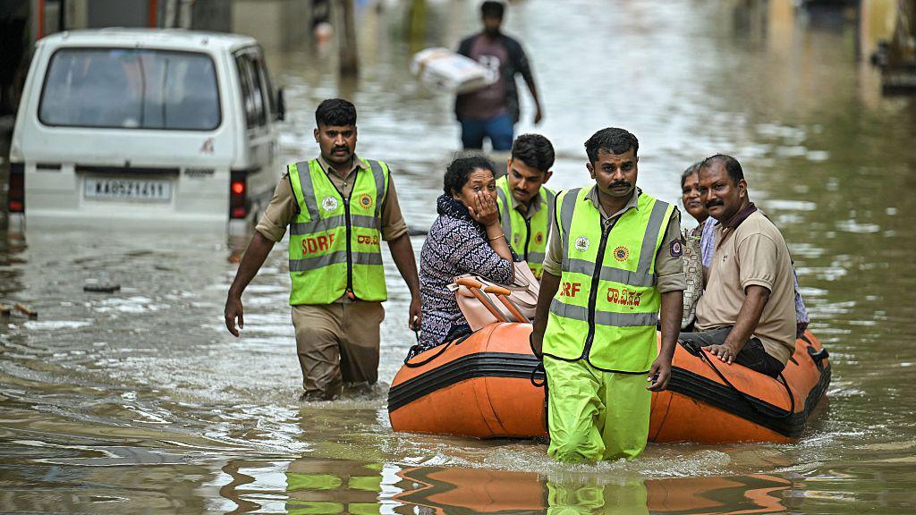 State Disaster Response Force (SDRF) personnel rescue residents from a flooded locality following heavy rainfall in Bengaluru on May 19, 2025.