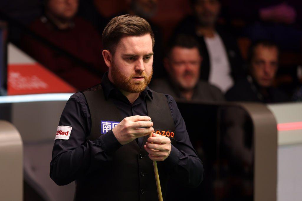 Jak Jones chalks his cue at the Crucible