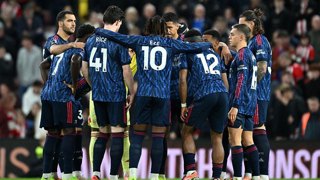 Arsenal players in a team huddle before the second half of the Premier League match at Sunderland