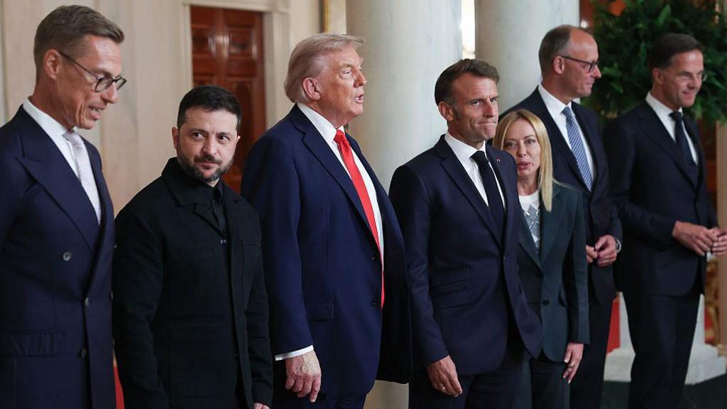 From left to right: Finnish President Alexander Stubb, Ukrainian President Volodymyr Zelensky, US President Donald Trump, French President Emmanuel Macron, Italian Prime Minister Giorgia Meloni, German Chancellor Friedrich Merz, and Nato secretary general Mark Rutte are pictured at the White House in Washington DC on 18 August, 2025.