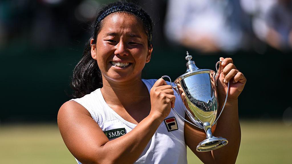Yui Kamiji of Japan poses with the trophy following her victory over Diede de Groot of the Netherlands in the Ladies' Wheelchair Singles Final