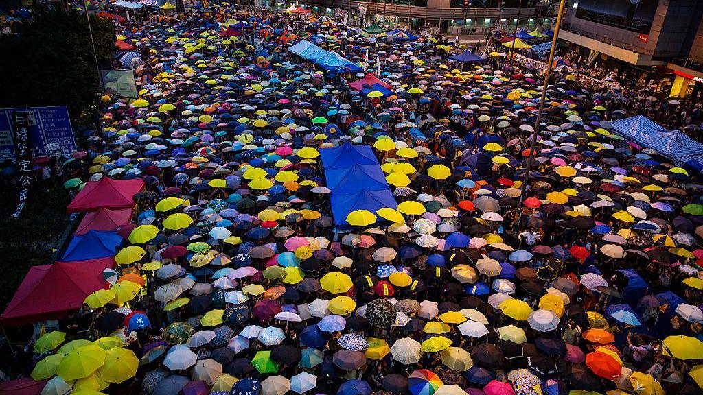 Umbrellas of various colours are opened as tens of thousands of people come to the main protest site one month after the Hong Kong police used tear gas to disperse protesters October 28, 2014 in Hong Kong. 