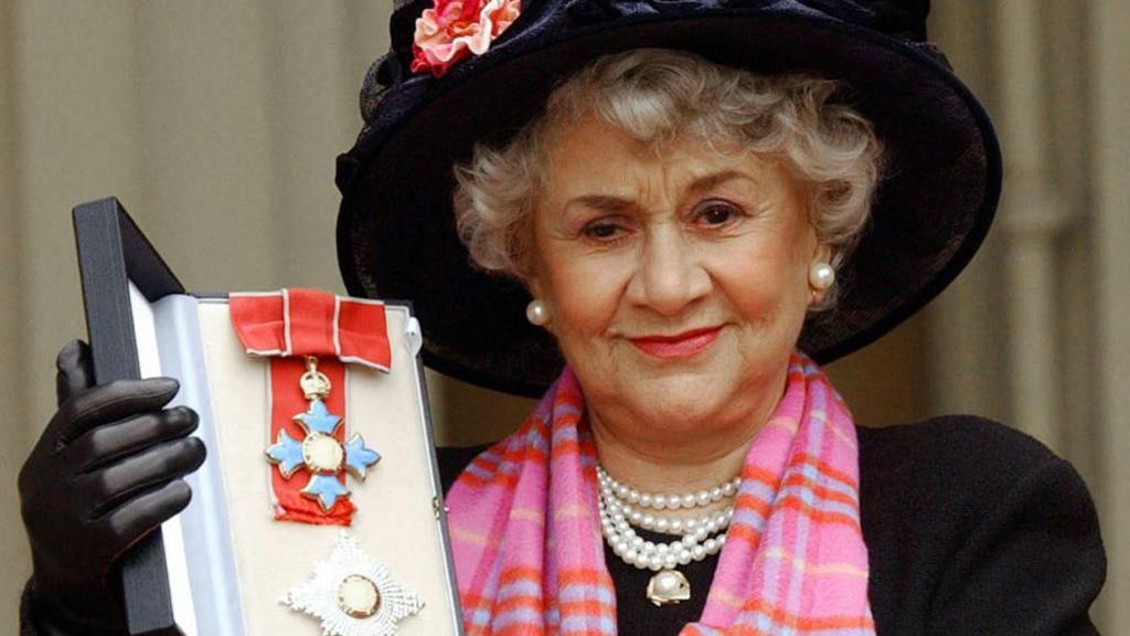 Joan Plowright became a Dame of the British Empire in 2004. She is photographed holding up the award