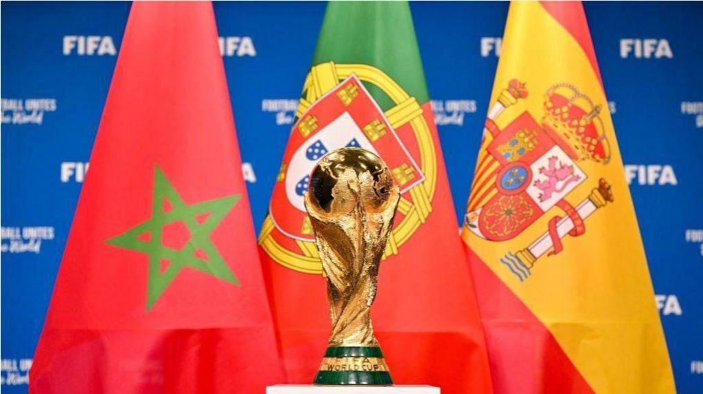 Fifa World Cup trophy standing in front of the flags of Morocco, Portugal and Spain.