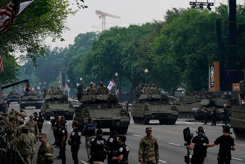Tanks pass a reviewing stand in Washington DC on 14 June 2025