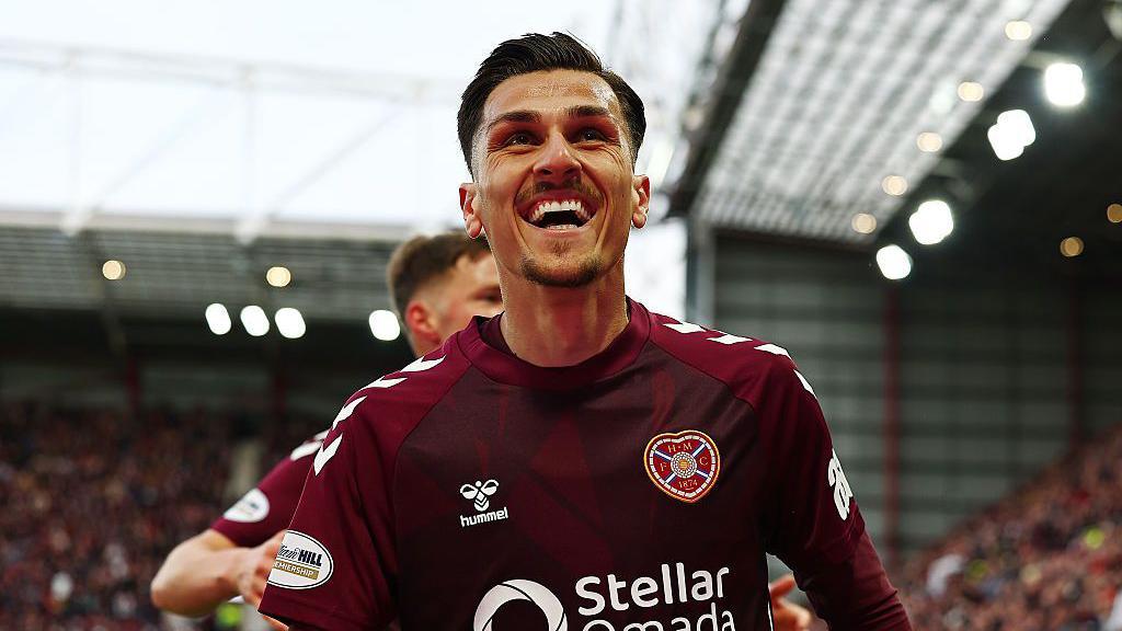 Alexandros Kyziridis celebrates, wearing Hearts' maroon home shirt