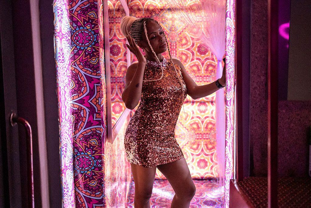 A customer poses for a photo in a decorated selfie room at Paper Nightclub in Abuja.