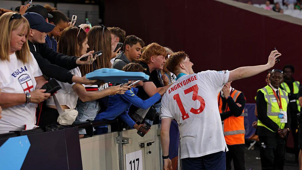 Man of the match Angryginge taking a selfie with fans. 