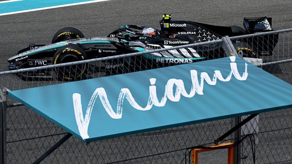 Kimi Antonelli drives past a Miami sign