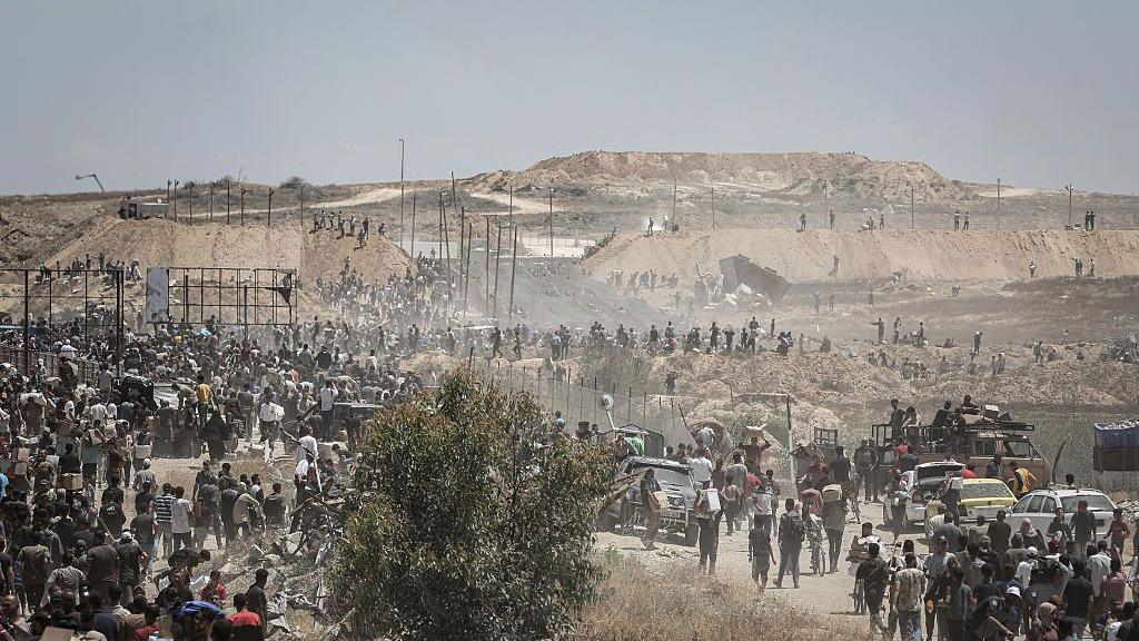 Palestinians at a distribution center for humanitarian aid in the Netzarim Corridor, central Gaza Strip, on Thursday, May 29, 2025
