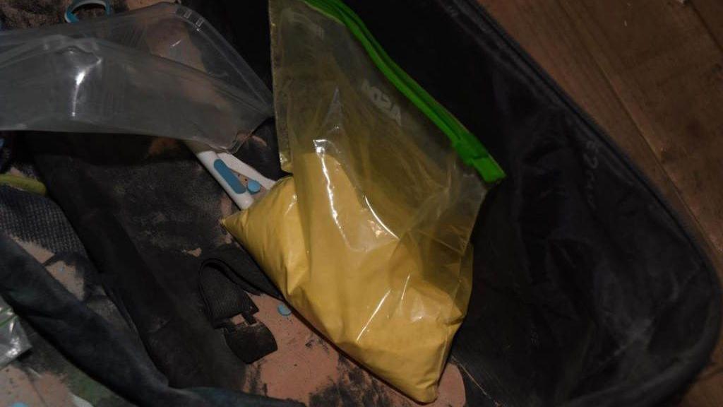 A clear bag of yellow-coloured power