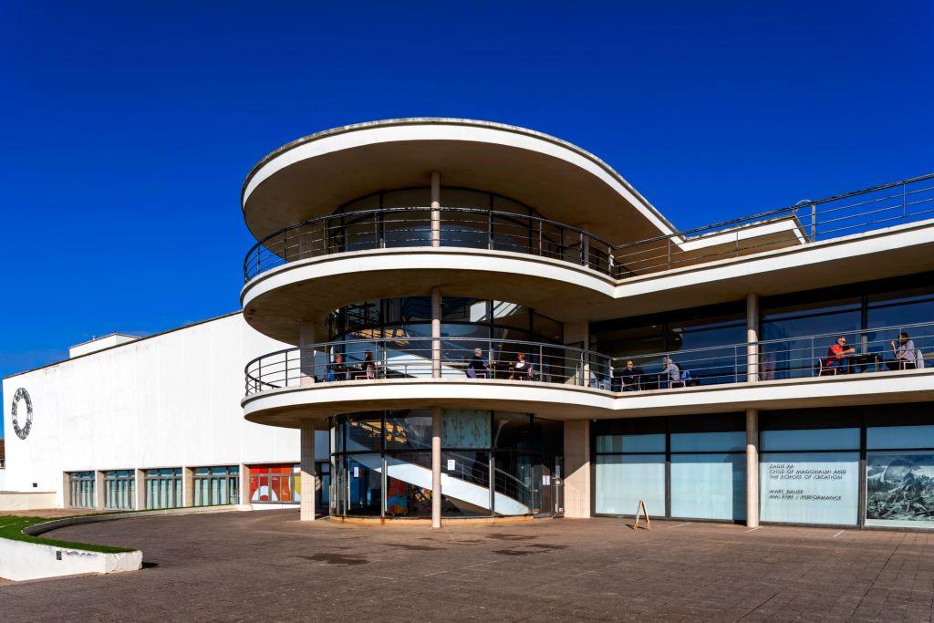 The De La Warr Pavilion on Bexhill seafront under bright blue skies. 