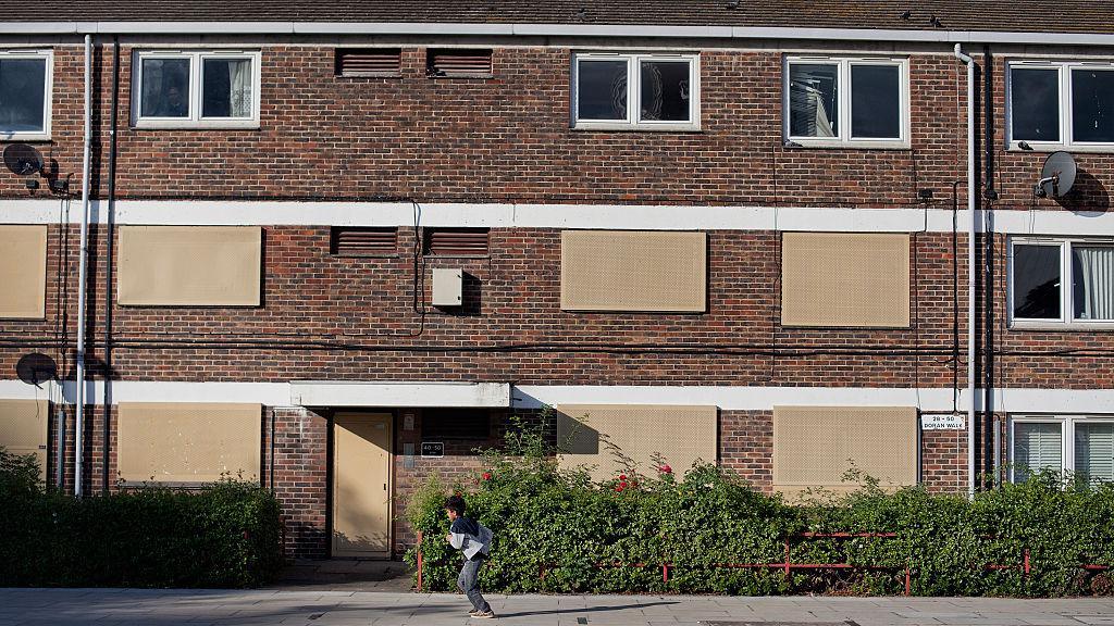 Windows in empty flats have been plugged with panels. 