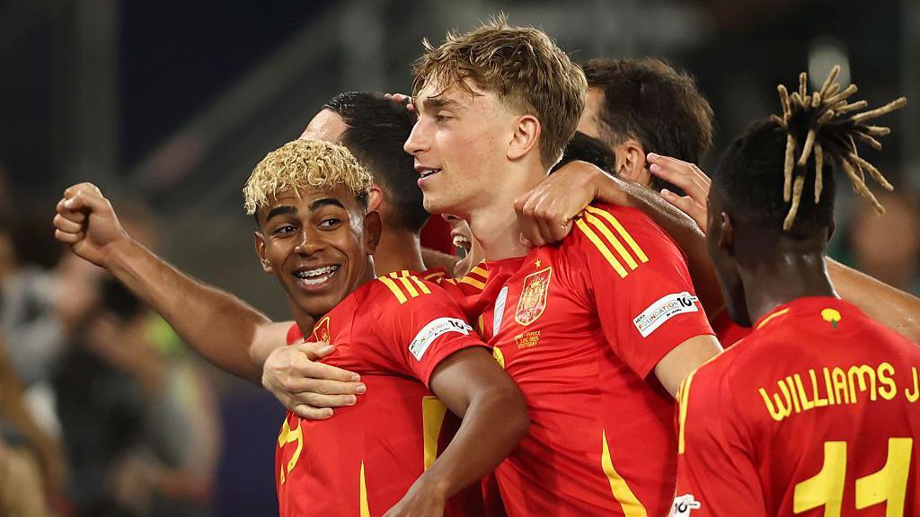 Lamine Yamal celebrating his goal with teammates.