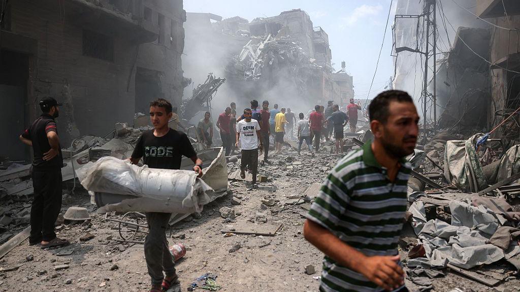 Palestinians check the devastation following an Israeli strike that hit Gaza City's southern al-Zeitoun neighbourhood on August 8, 2025.