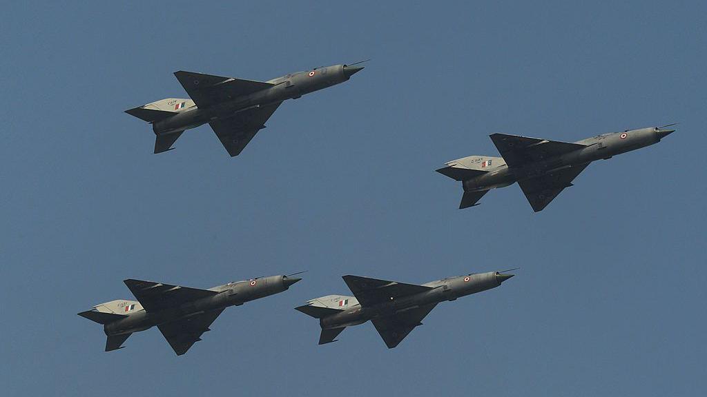 Indian Air Force of MIG 21FL fighter aircraft are seen in a 'Box' formation for the final time during a fly-past at the last ceremonial flight of the MIG 21 at a phasing out ceremony at Air Force Station Kalikunda (WB) near Kharagpur, some 110kms west of Kolkata on December 11, 2013. Three MiG-27 aircraft performed the Trishul Break Manoeuvre as a salute to the MiG-21 type 77 aircraft, which were first inducted in March-April 1963 and heralded the arrival of the Indian Air Force in the Supersonic era. AFP PHOTO/Dibyangshu SARKAR (Photo credit should read DIBYANGSHU SARKAR/AFP via Getty Images)