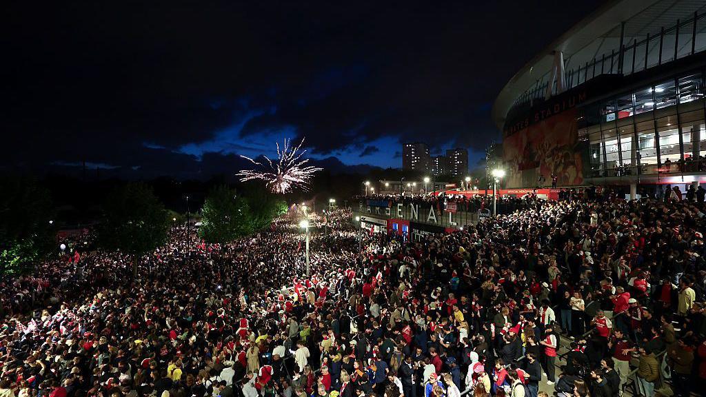 Fans gathering in huge numbers outside the Emirates Stadium to celebrate Arsenal winning the Premier League