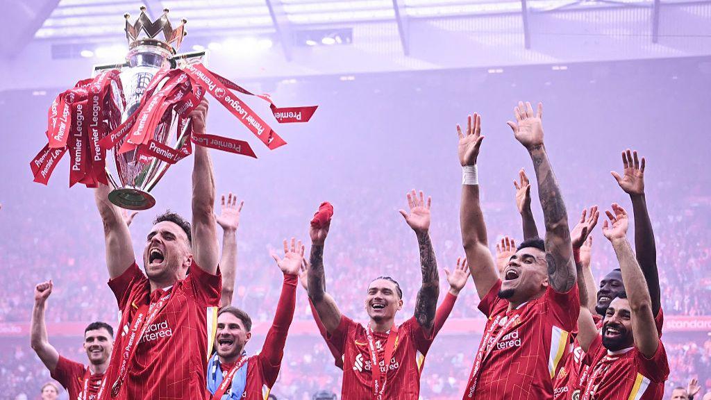 Jota lifting Premier League trophy