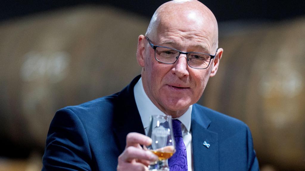 john swinney with glass of whisky