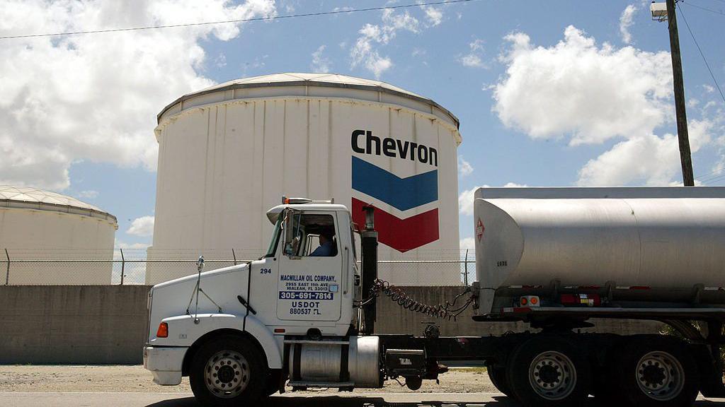 A gas tanker passes a Chevron petroleum storage tank at Port Everglades May 24, 2004 in Fort Lauderdale, Florida.
