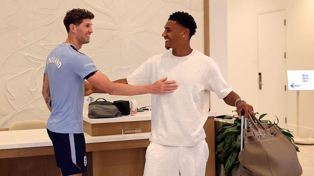 Ollie Watkins is greeted by John Stones