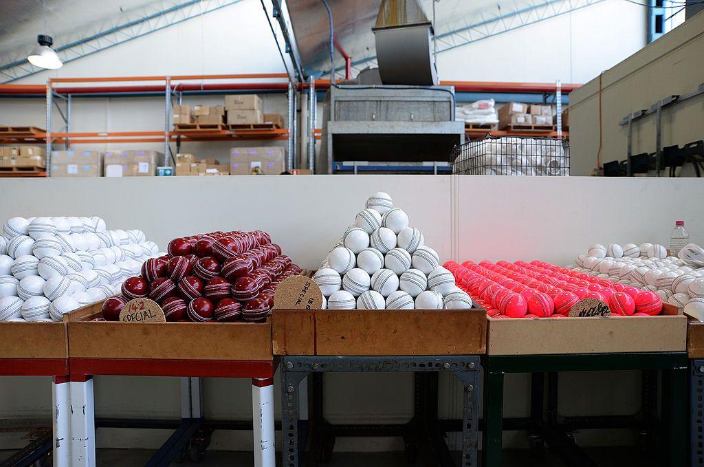 Boxes of red, white, and pink cricket balls sit in the Kookaburra factory in Melbourne, Australia.