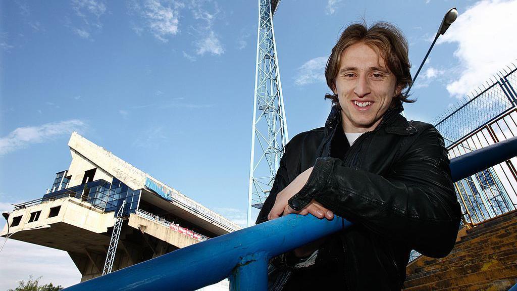 Luka Modric leaning on a terrace barrier