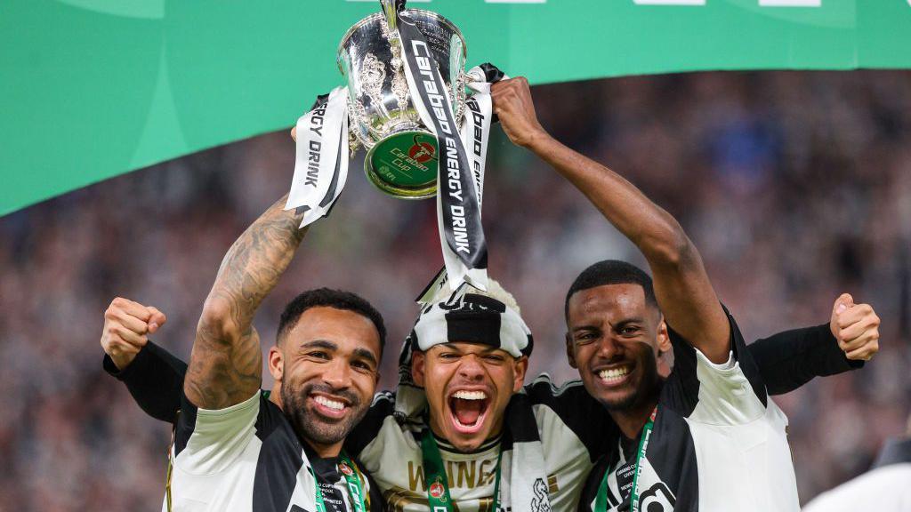 Newcastle players celebrate the trophy win