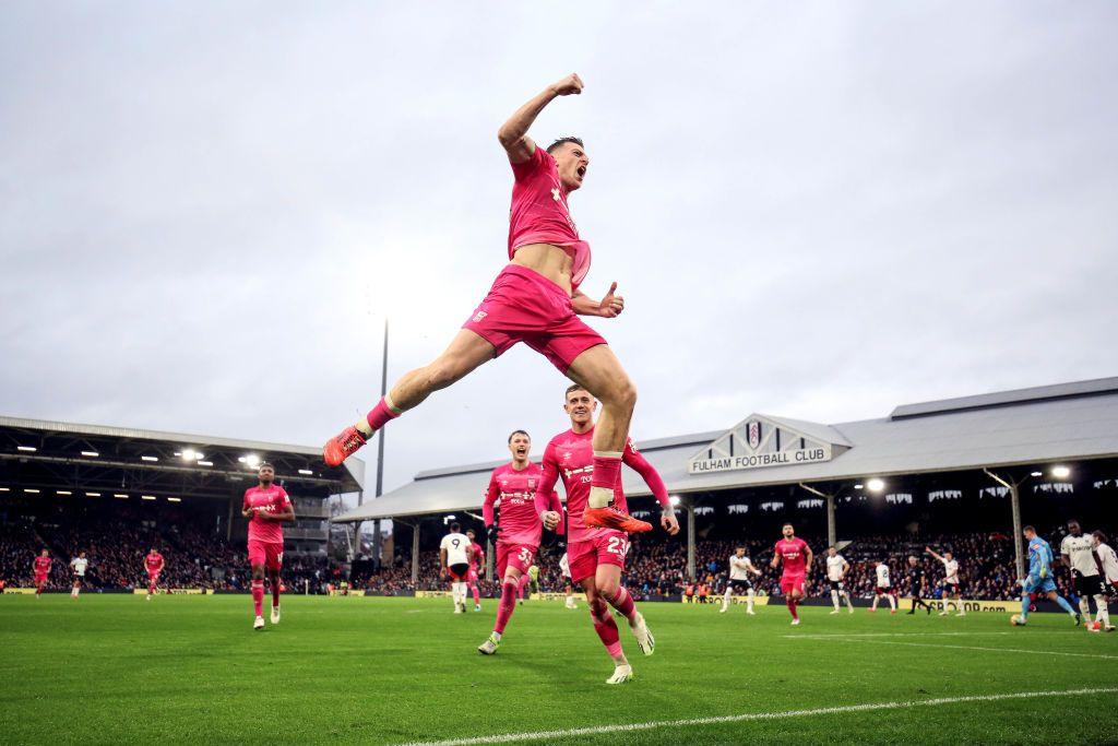 Ipswich's Liam Delap leaps in the air in front of fans as he celebrates the visitors' second goal at Craven Cottage