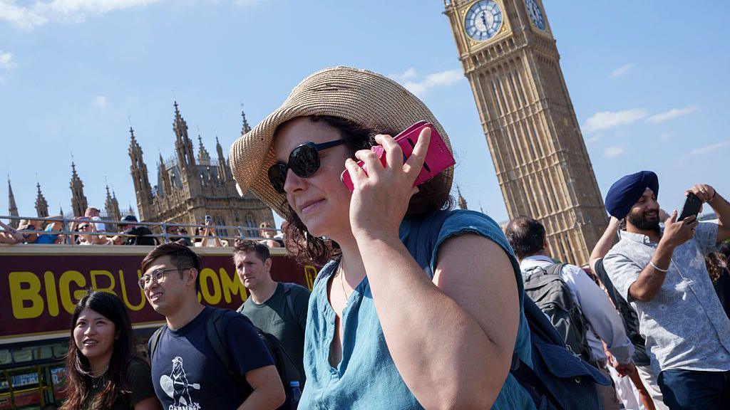 As the fifth UK heatwave of the year sends temperatures back into the 30s degrees Celcius this week, visitors to Westminster Bridge sightsee in the capital, on 11th August 2026, in London, England