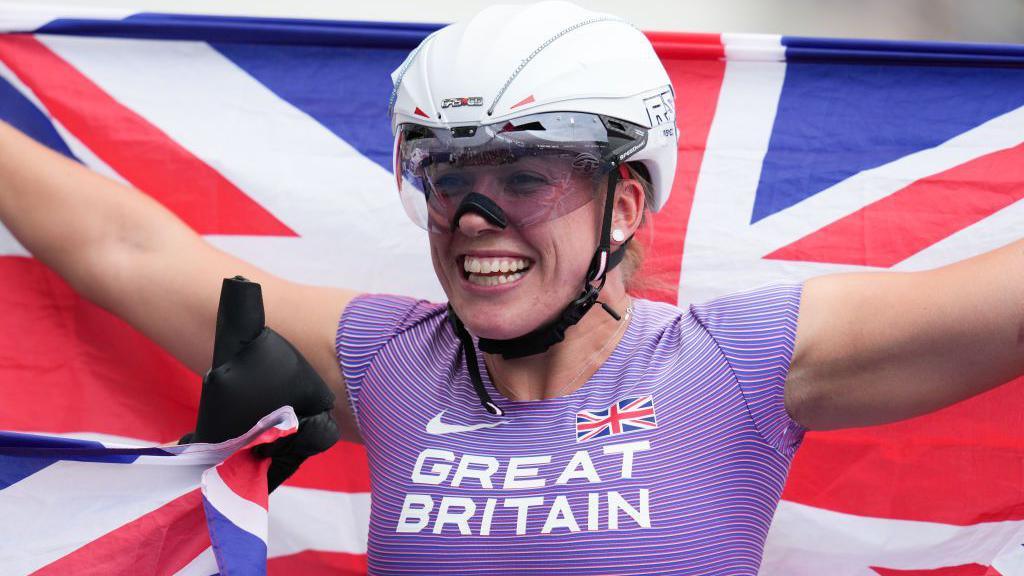 Hannah Cockroft celebrating with the Union flag after winning a gold at the Para Athletics World Championships