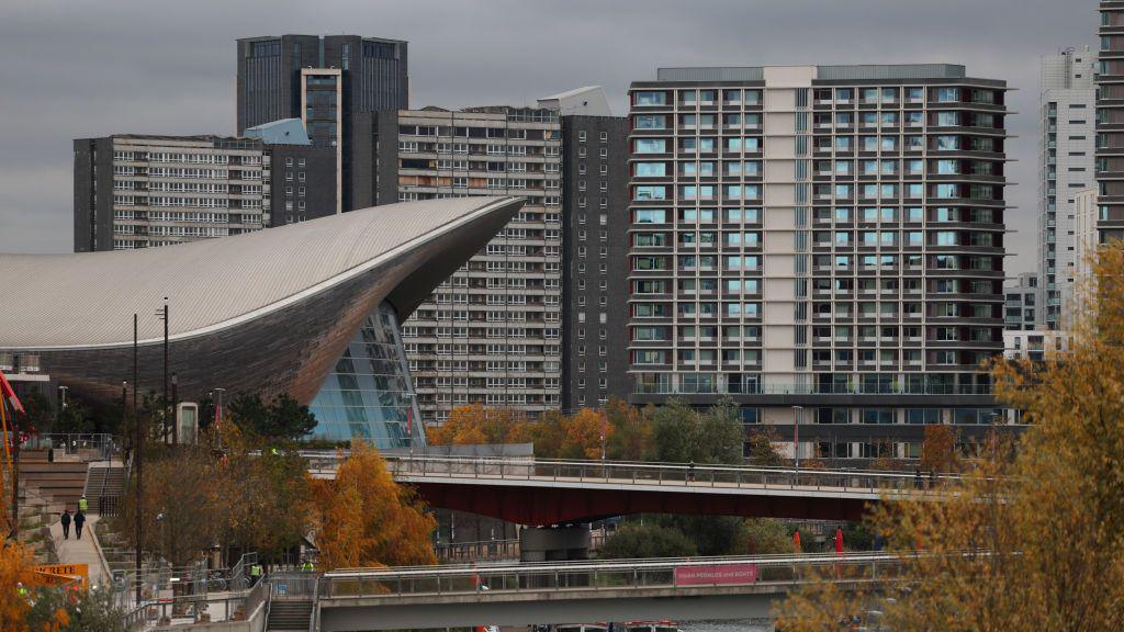 The London Aquatics Centre located next to a residential buildings at the Olympic Park