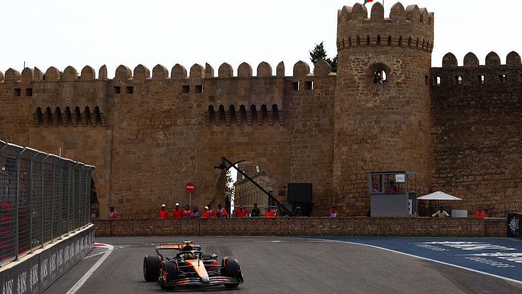 McLaren's Lando Norris with a castle in the background during Azerbaijan Grand Prix first practice