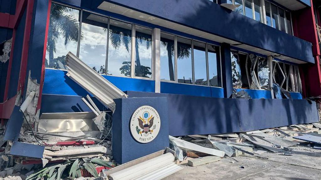  This photo shows a general view of a severely damaged building housing the embassies of the United States, United Kingdom, and New Zealand after a powerful earthquake struck Port Vila